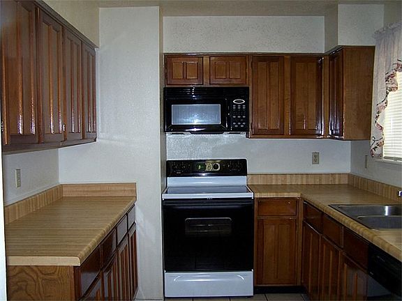 Great kitchen with smooth-top range, microwave, and dishwasher. Window overlooks backyard.