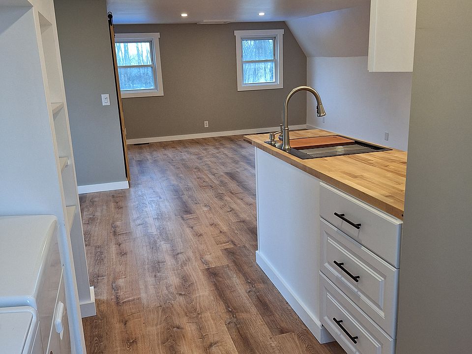looking in from doorway, bathroom door on right, washer and dryer on left