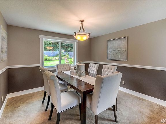 Dining room overlooks backyard. 