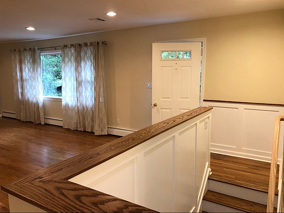 Front door and stairs to basement.