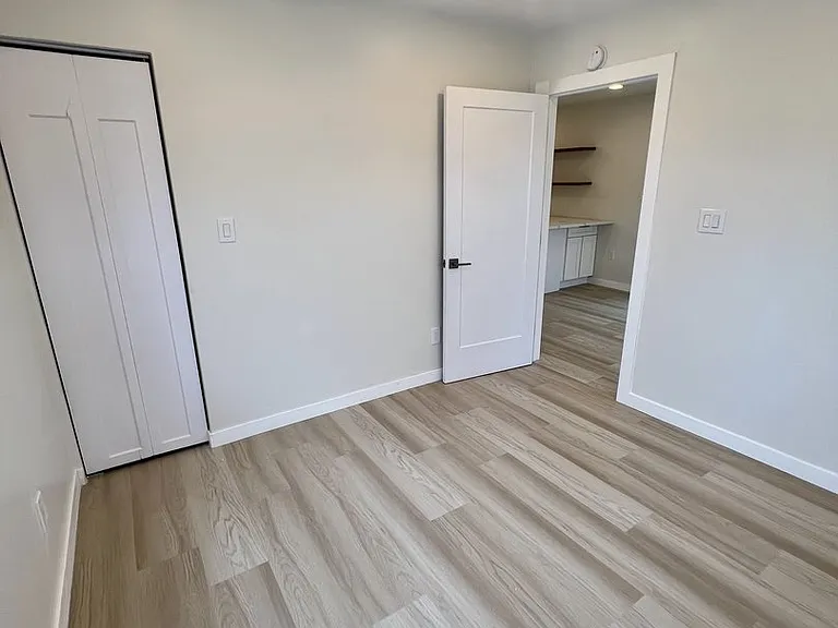 left bedroom with ceiling fan
