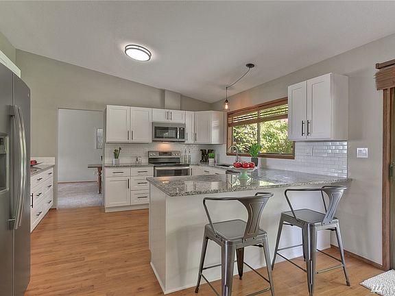 The Kitchen has been lovingly updated with granite counters, white cabinets, subway tile, all new cabinets, lighting and hardware.