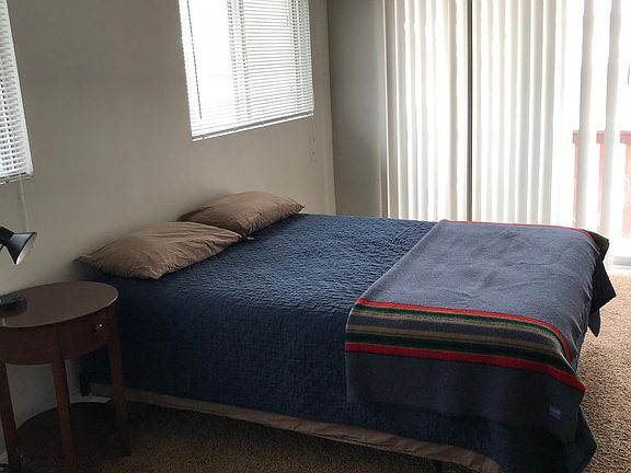 Large master bedroom with new comfortable queen bed and slid