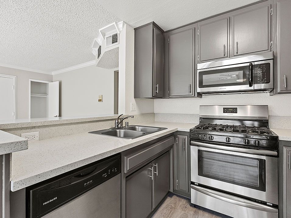 Kitchen with stainless steel oven, microwave, and dishwasher.