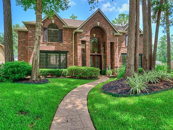 Stylish stamped concrete walk way leads the way to the grand double door entrance.