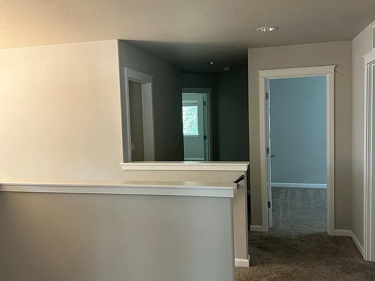 Upstairs landing with a small bonus space to the left. All bedrooms and laundry upstairs.