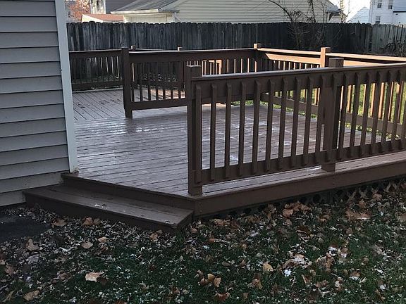 Deck off the back of the house and the partial fence.