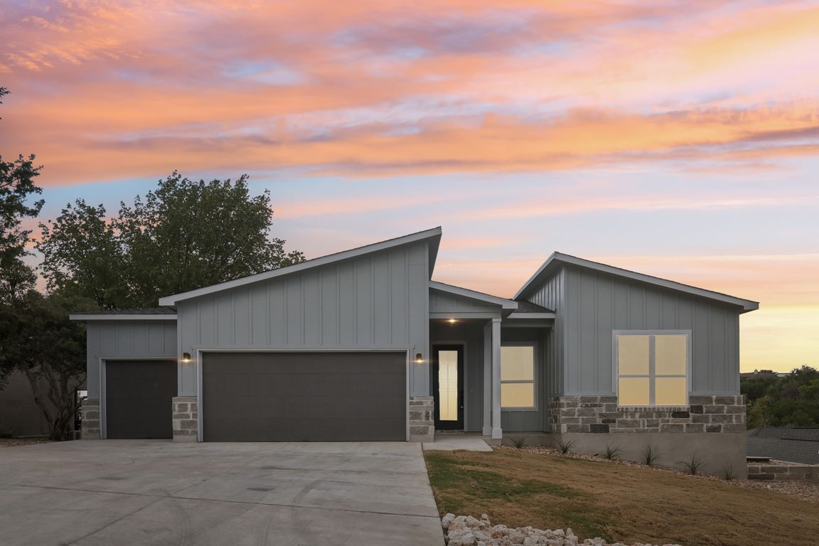 Front of house featuring three car garage