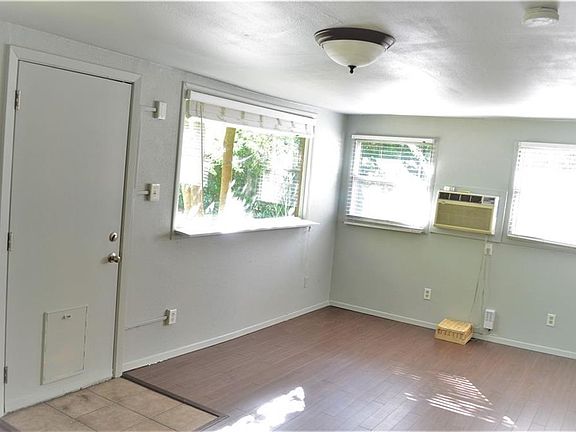 2nd living room. Goes out to backyard. Has a doggie door. This space was previously used as an art studio. It can be used as a 2nd living room, studio, playroom, office etc.