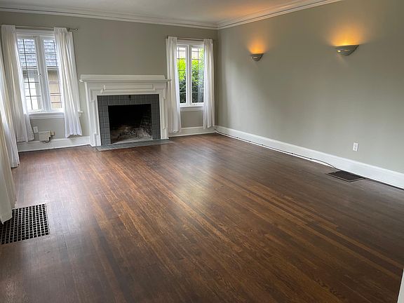 Large living room with fire burning fireplace