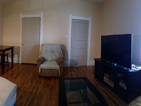 Comfortably sized living room with orginal hard wood floors