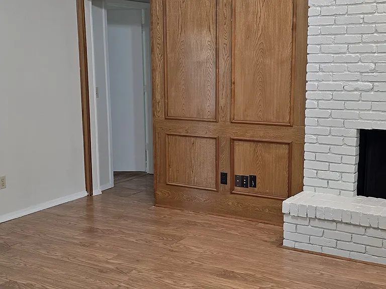 beautiful paneling finish out in lv with tall ceilings, and ceiling fan with engineer flooring