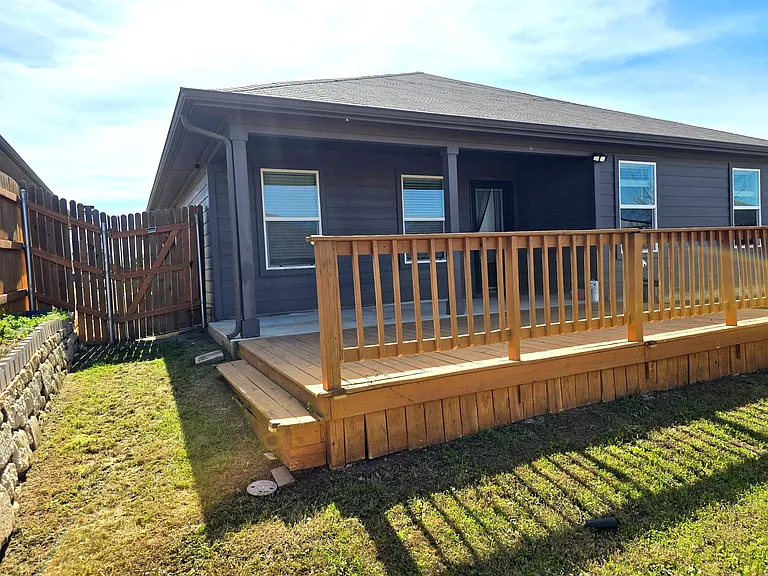 Expansive deck connected to backyard space for outdoor activities.