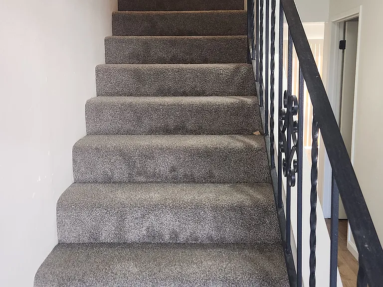 stairs going upstairs to two bedrooms and full bath