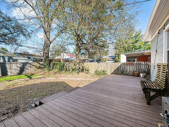 fenced in backyard with deck