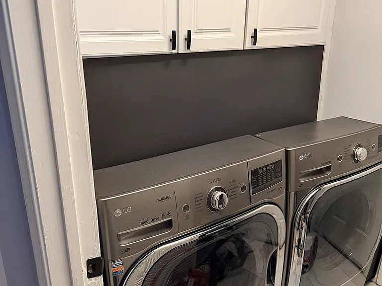 Laundry room connecting to the garage on the ground level.