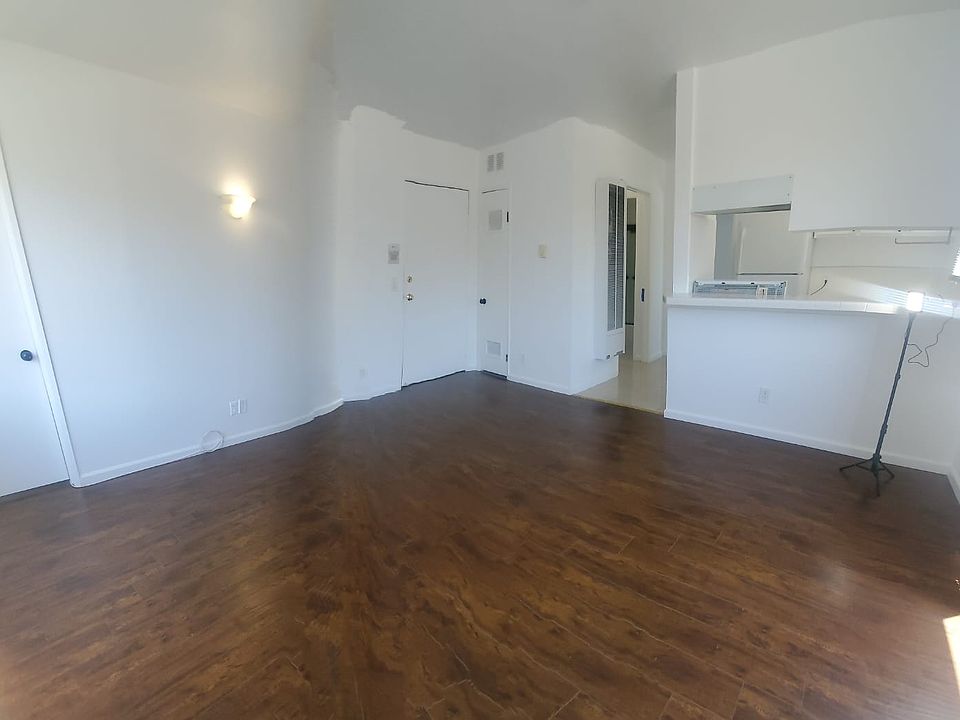 ANOTHER ANGLE OF THE LIVING ROOM, FACING THE KITCHEN AND FRONT DOOR