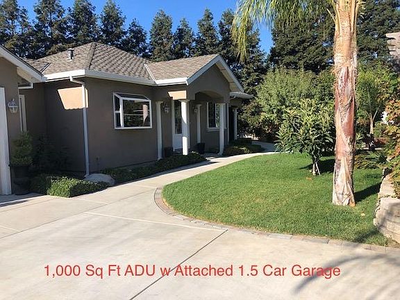 Driveway to attached garage with electric opener and sidewalk to front door.