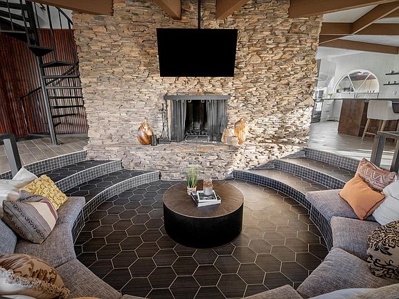 Conversation Pit, 65'' TV over the stone wood burning fireplace