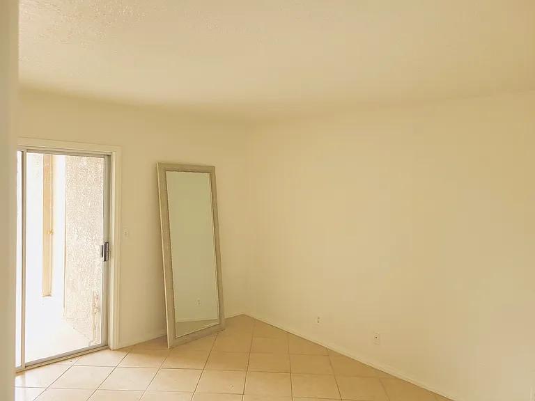 Primary Bedroom With Sliding Door to Back Patio and Laundry Room