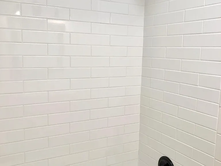 All new bathroom tile, tub and fixtures. Shower head is raised for tall men. Tile goes to the ceiling.