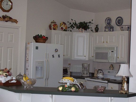 Kitchen has a lot to offer, pantry, built in microwave, and bar.