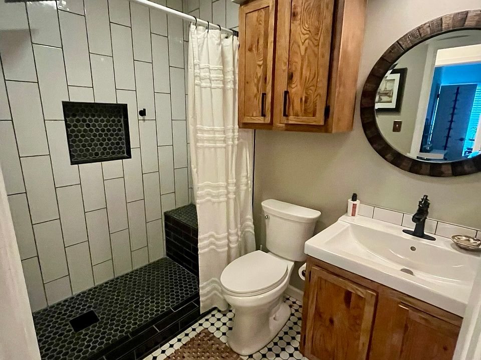 Guest bathroom off of hallway. Recently renovated shower with bench and second removable shower head.