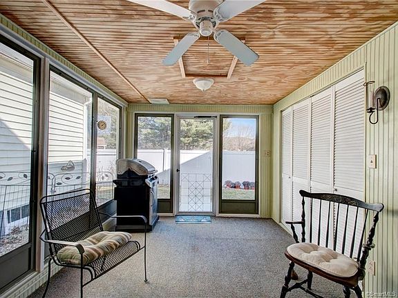 Sunroom with windows and screen off entry and access to backyard.