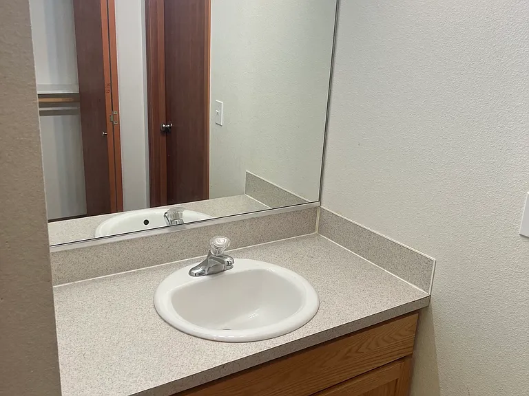 Extra vanity in master second master closet shown in mirror