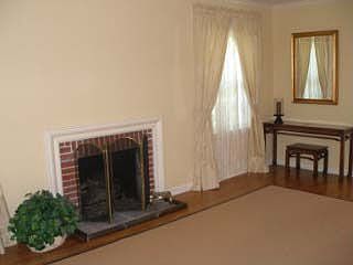 Living room fireplace has gas logs.