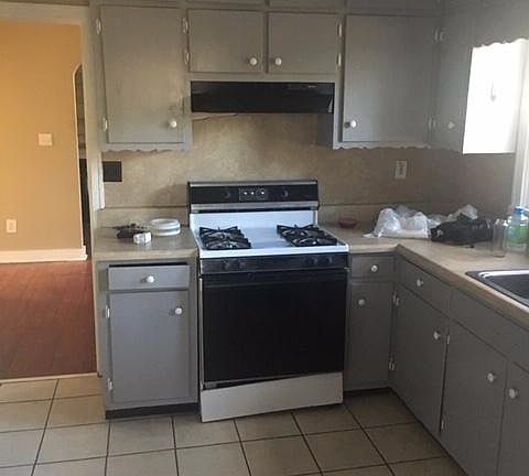 Kitchen with tile floor bathroom . Gas range-one year old.