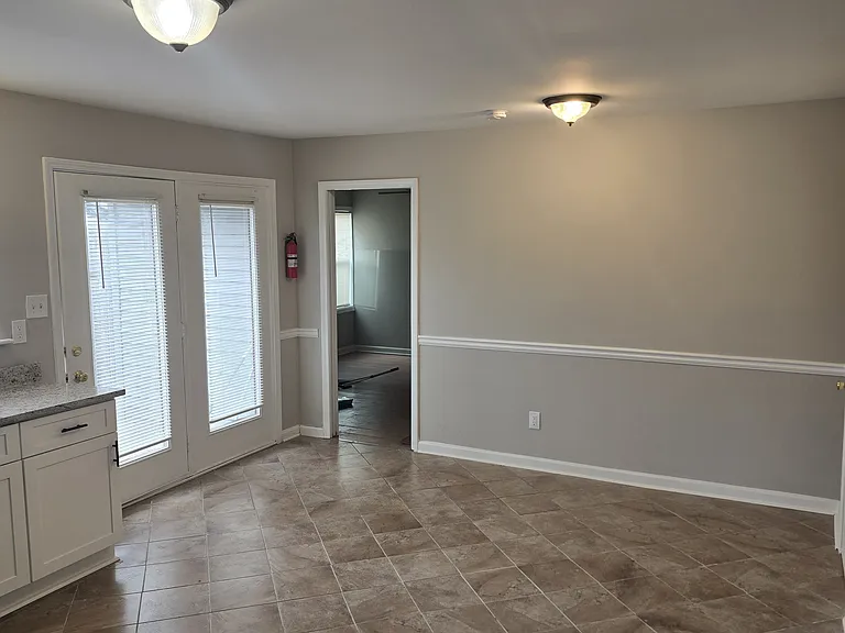 Kitchen with a view of the entryway to the two connecting bedrooms.