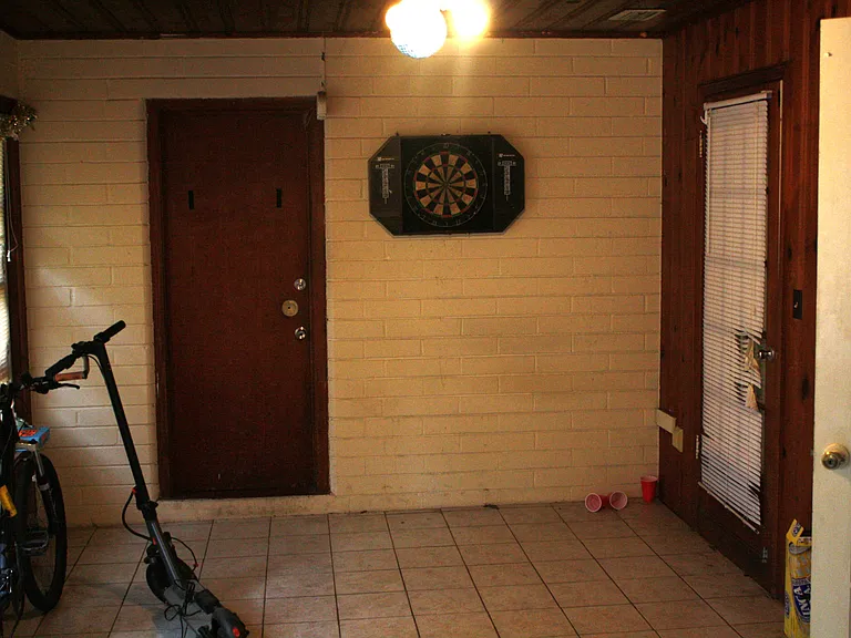 Sun porch or fourth bedroom, door accesses garage and laundry
