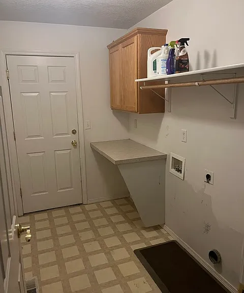 Washer/dryer hookups, folding area and large cabinet!