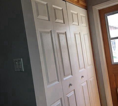 laundry room area behind doors