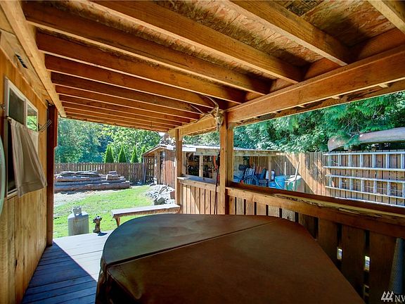 Back patio is covered and includes a hot-tub for relaxing moments. 