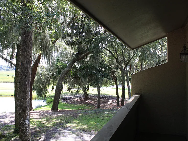 View from upper balcony to pond, 9th hole of golf course, and marsh.