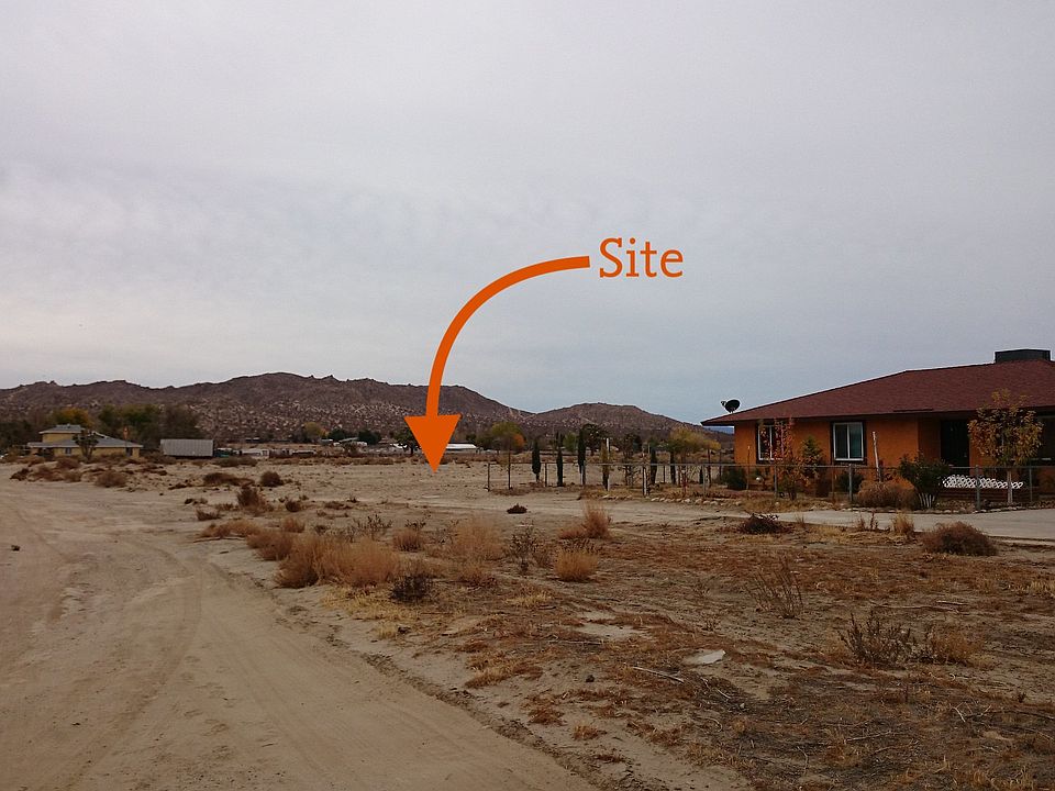 Adjacent to fenced houses.