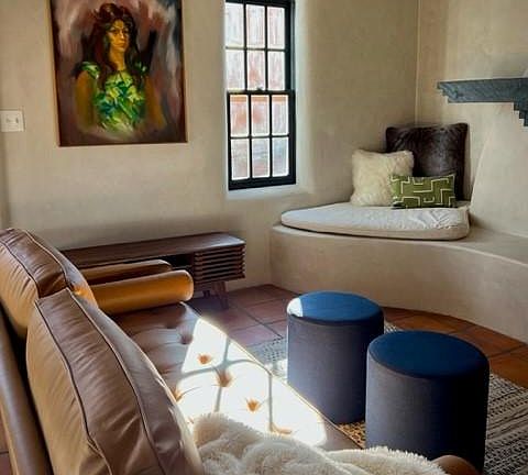 Leather couch and swivel chair provide comfortable seating in the living room.