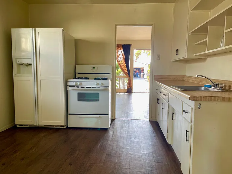 Kitchen view looking into the living room. Gas stove and refrigerator with ice maker and front serving water. LOTS of cabinet space.