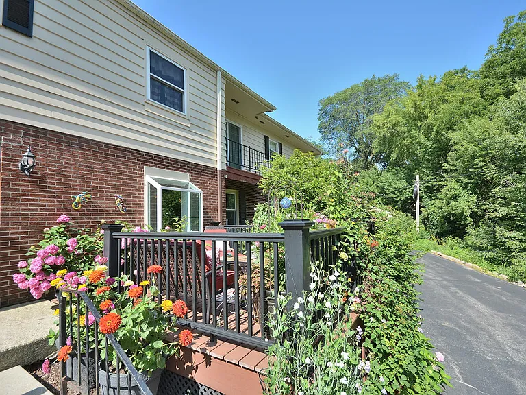 Steps with hand railings and rear entrance door into Building 13350 (left)
Dedicated Deck with wrought iron surround for Unit #1 only (right)