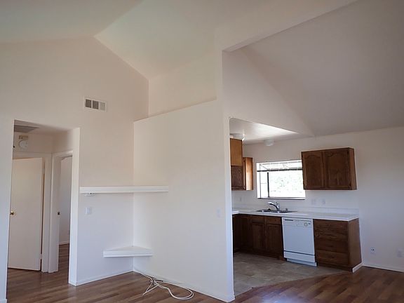 Living room and kitchen. Unit features tall ceilings for extra space