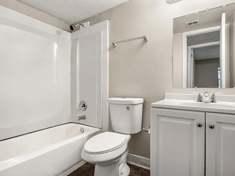 Bright and inviting bathroom with a modern bathtub, sleek vanity, and elegant fixtures.