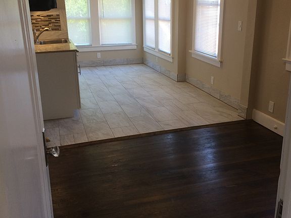 Leaving the front room and entering the second living area (most use this room for entertaining) and open to kitchen (stainless refrigerator and stove not pictured but included).