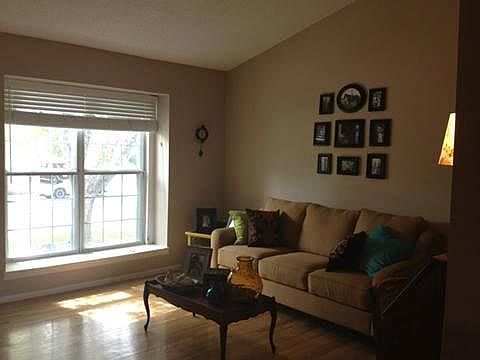 Front room with large window and wood floors