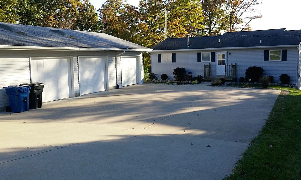 Fantastic Waterfront Home with 91 Ft on Sanford Lake! Perfect get-away or year round home with many updates. Beautiful updated kitchen features white cabinetry, granite countertops and tile backsplash, plus a 7 foot granite island and brand new stainless appliances! New flooring throughout most of the home. Great Room layout with wood burning fireplace overlooks expansive lawn and waterfront view! New garage addition with skylights and 220 electric can accommodate 4 cars! Walk out lower level features huge family room with bar and 1/2 bath, plus laundry and storage room. Updated electrical service, New Boiler and Central Air in the last 2 years. Washer, dryer,and extra refrigerator stay as well as 2 new 24 foot docks! Furniture and Boats are available! Great location near State Land. Natural gas is hooked up and City water is available at the road. 