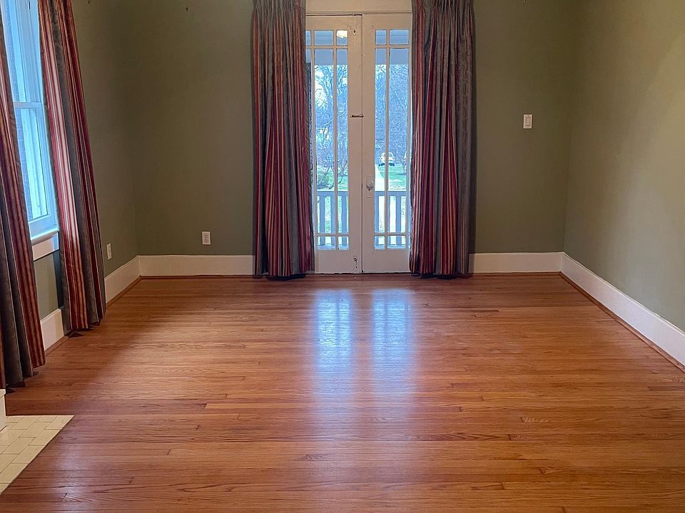 Living room. Has a non functioning fireplace. Access to front patio/balcony.