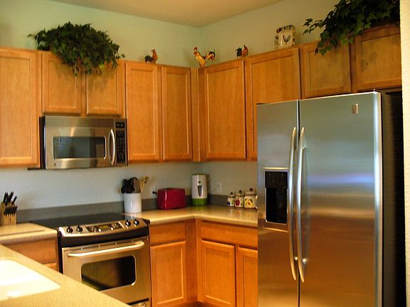 oversized cabinets, corian counters, stainless steel appliances