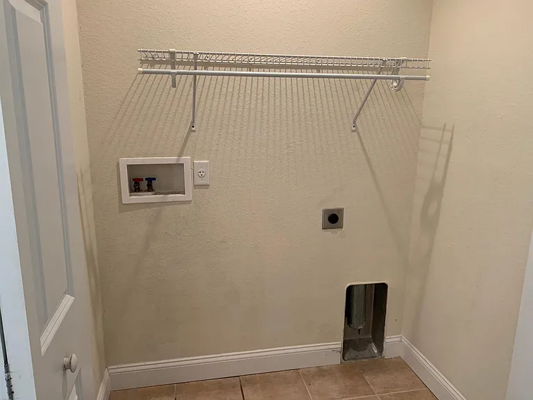 (what the laundry space looks like behind the w/d units