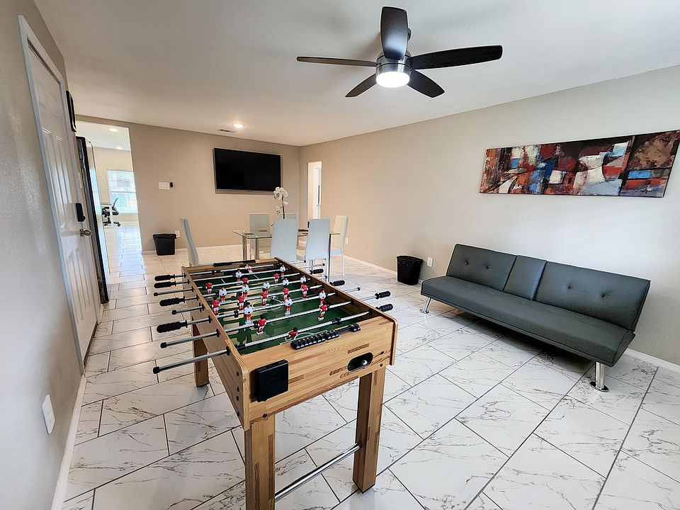Game room for Guests with Foss ball Table, 65 inch Amazon Smart TV and futon couch.